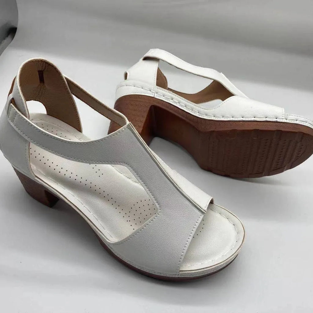 Plus size women's beige peep toe wedge sandals with a buckle strap and low heel.