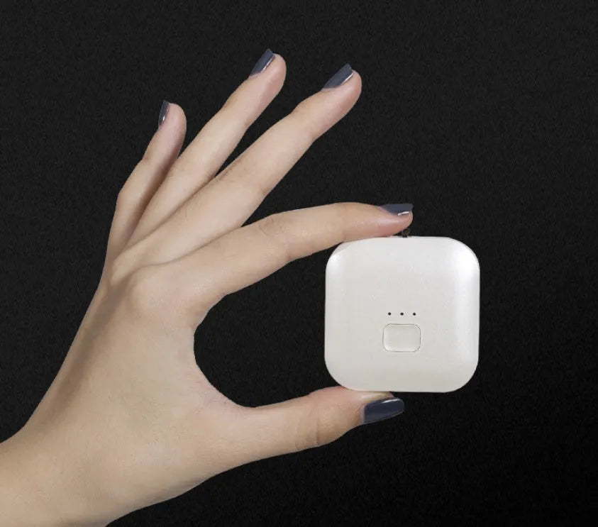 Mini USB portable air purifier necklace in blue, shown worn and with USB cable.
