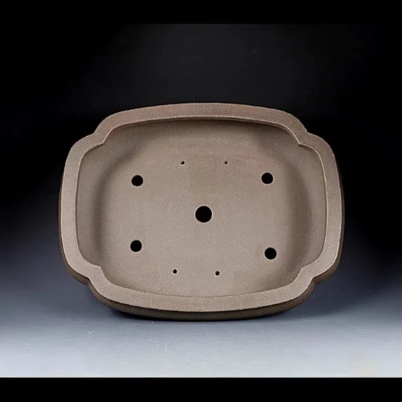Handmade antique Pukou style papaya-shaped purple clay flower pot on a table.