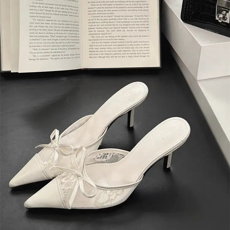 Women's light brown high heels with a pointed toe, decorative bowknot, and mesh upper.