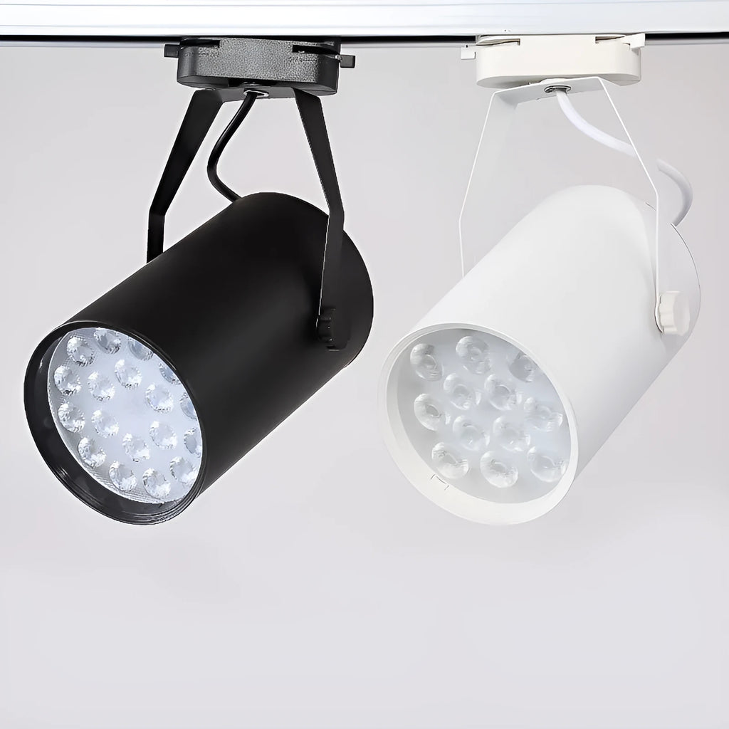 Black and white aluminium LED track spotlight on a lighting track, aimed at a display.