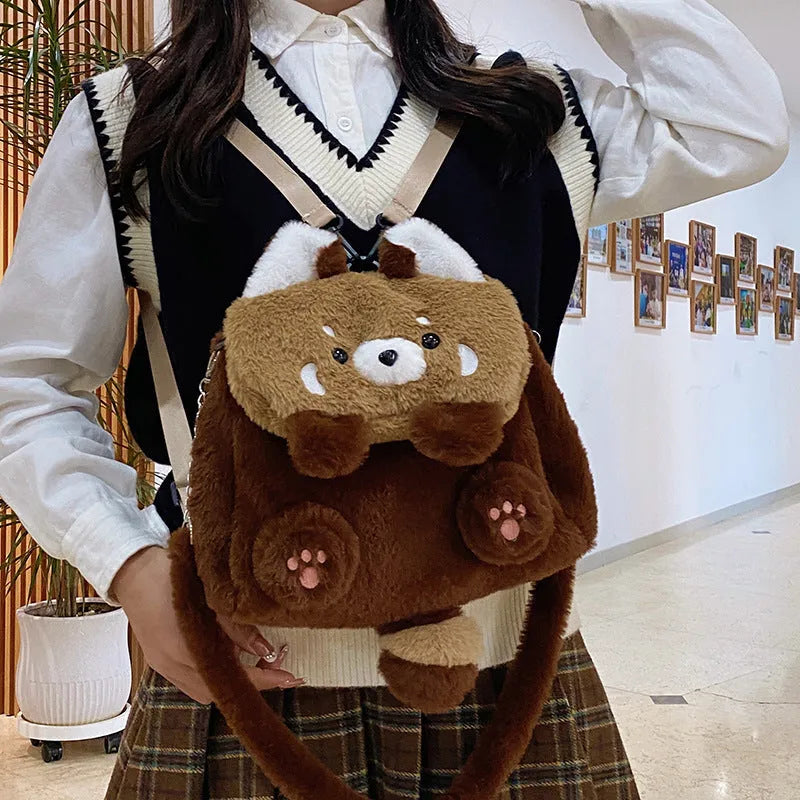 Brown coati plush bag doll cartoon backpack on display showing soft fabric and animal face design