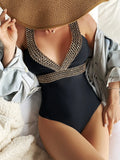 Women's deep V neck one-piece swimsuit with spaghetti straps on a hanger
