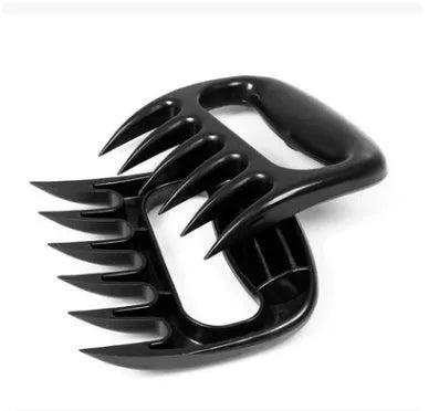 Two black bear claw meat shredders for BBQ preparation on a kitchen counter.