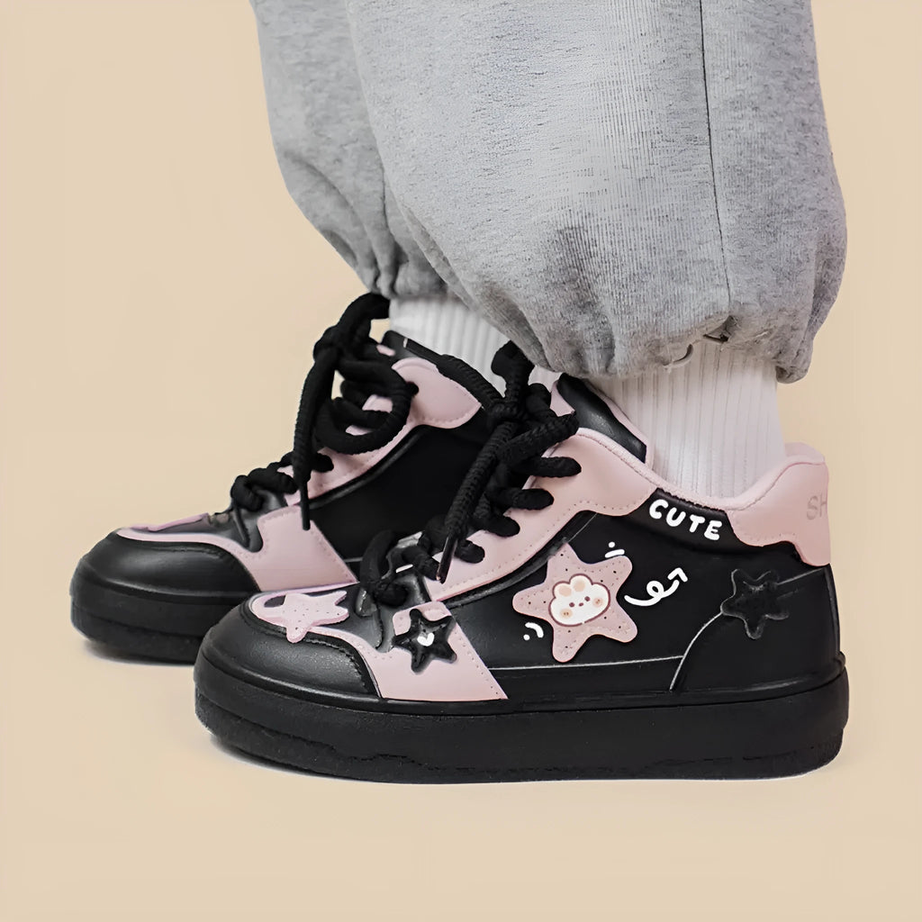 Women's black high top sneakers with cartoon anime pattern, colour blocking, cross straps, and lace-up closure