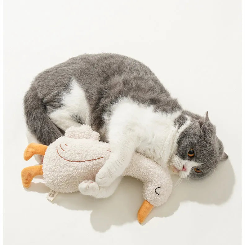 Red fox-shaped and yellow duckling-shaped plush dog toys on a plain background.