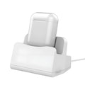 White plastic headphone charging base for wireless earbuds on desk
