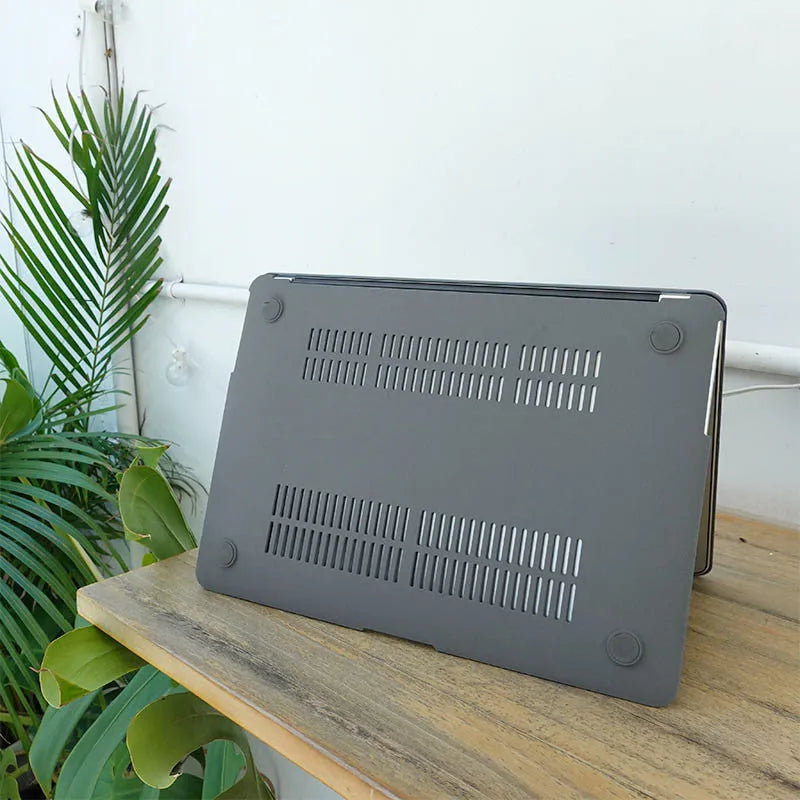 Quicksand Cobalt Gray polycarbonate protective shell for MacBook laptop on a desk