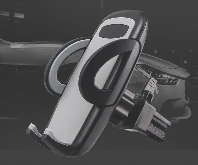 Black plastic car phone holder mounted on air conditioning outlet holding smartphone