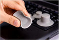 Set of four grey plastic laptop cooling pads with non-slip rubber feet, shown elevating a silver laptop.