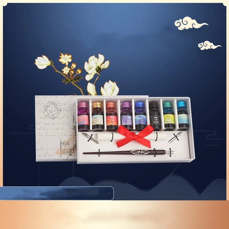 Wooden dip pen set with eight coloured ink bottles, two nibs, and blank paper in a wooden box