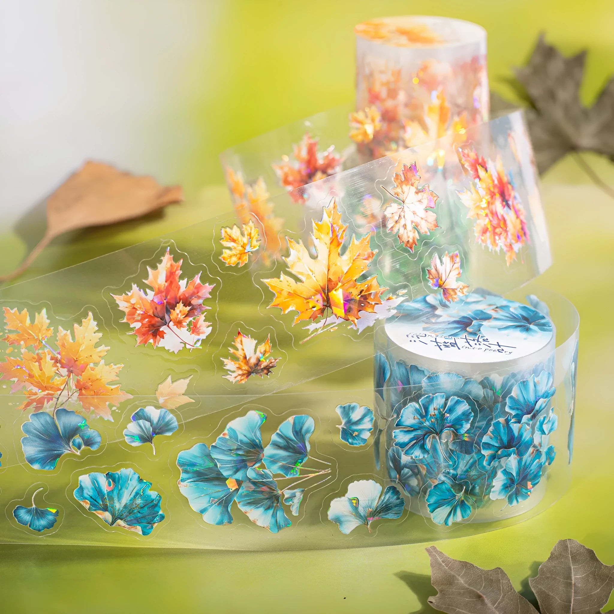 Roll of 40mm wide decorative PET stickers showing six leaf and nature designs including ginkgo and maple motifs.