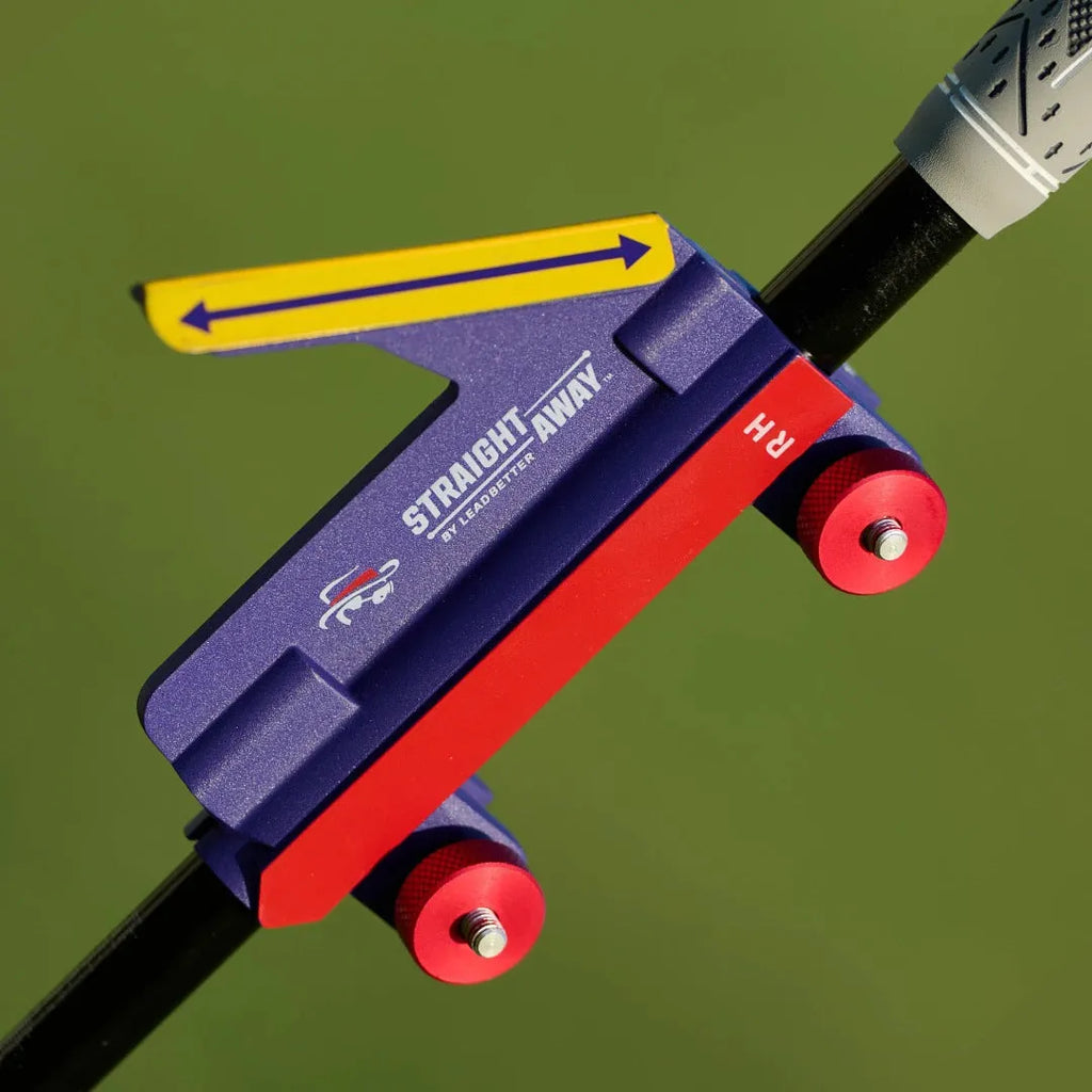 Plastic golf swing plane simulator trainer on a practice mat.