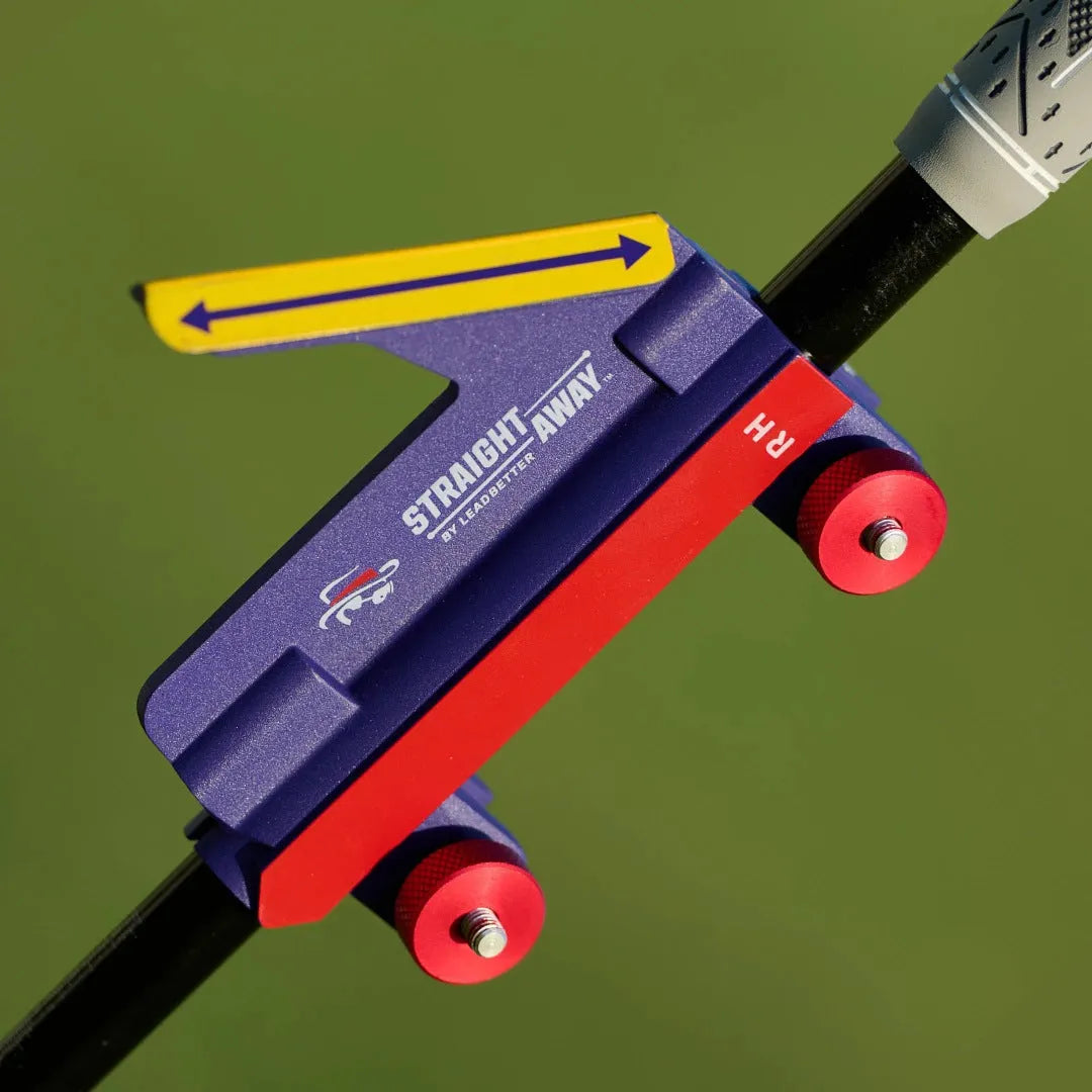 Plastic golf swing plane simulator trainer on a practice mat.