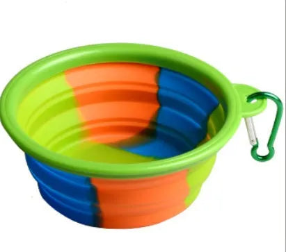 Collapsible silicone dog bowl in camouflage pattern folded flat on green surface
