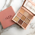 Nine-colour eyeshadow palette with warm brown, charred orange, and nude matte and pearlescent shades