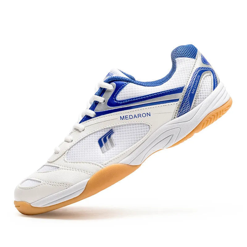 Table tennis sneakers in white and red colour with mesh upper, natural rubber outsole and front lace-up closure
