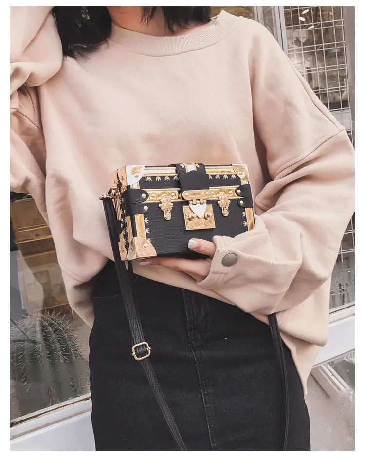 Structured hard PU women's shoulder bag with a flap, hasp closure, and adjustable strap.