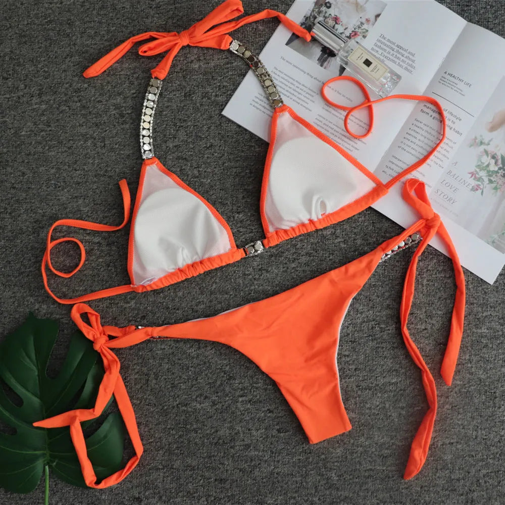 Strapless solid colour bikini in black, orange, white, or yellow, nylon outer and polyester lining, sizes S M L
