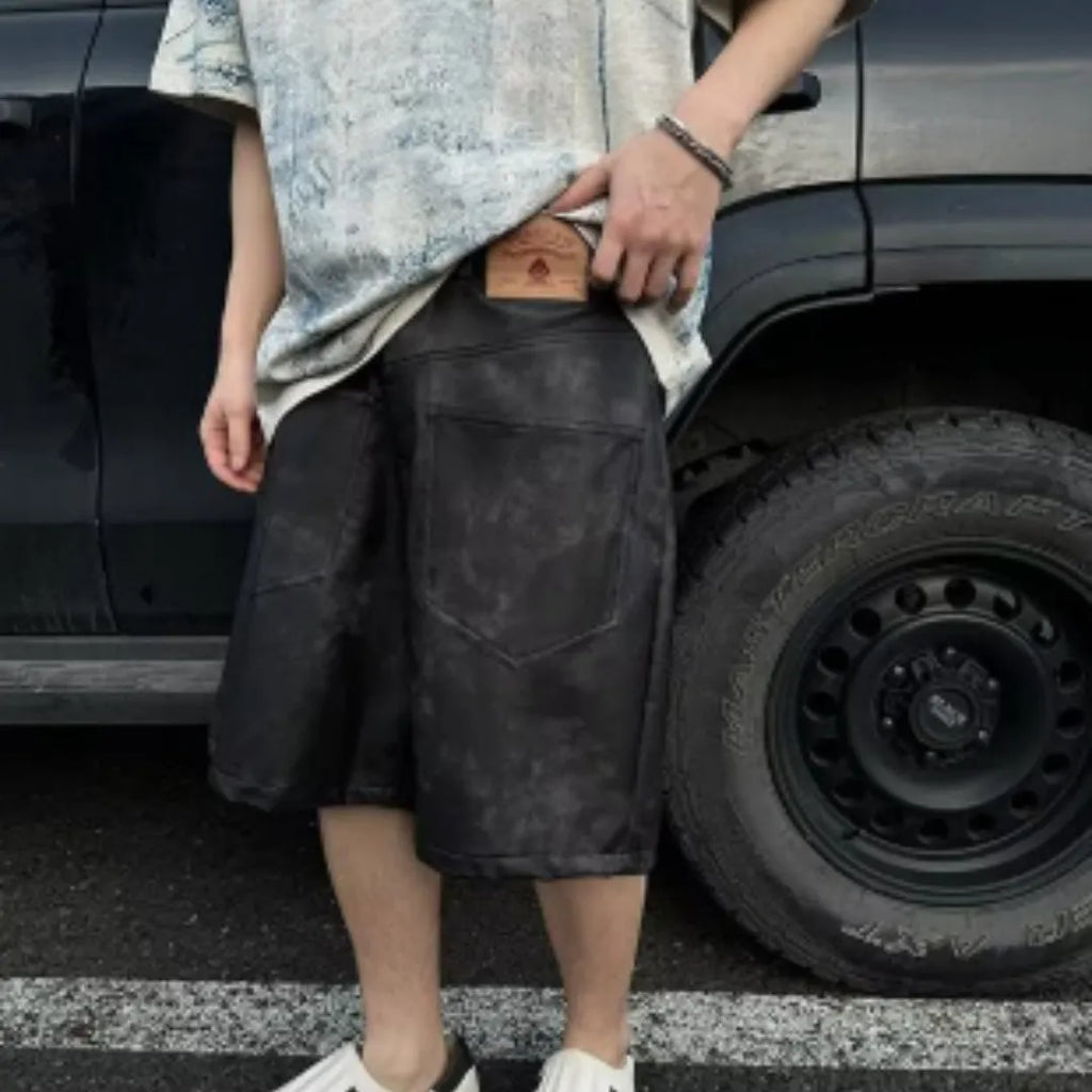Men's loose-fit short-sleeve T-shirt with distressed print and tie-dye pattern on grey fabric.
