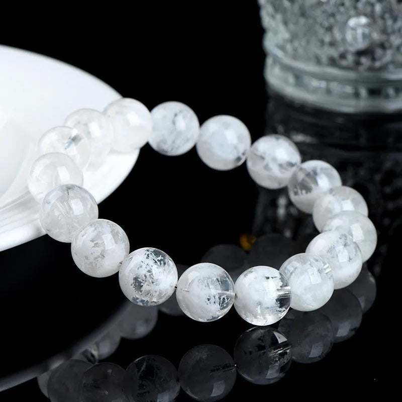 Original design women's crystal bracelet with natural blizzard snowflake round beads on a wrist.