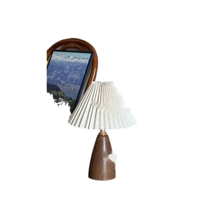 Nordic retro ceramic table lamp with pleated floral shade and remote control on a wooden bedside table.