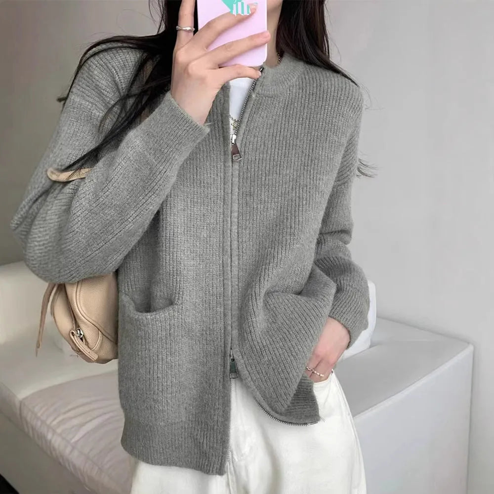Beige temperature-sensitive viscose sweater coat, long sleeve cardigan style on a hanger.