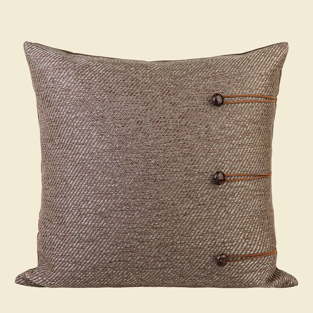 Square Chinese style decorative cushion in brown geometric patterns on a sofa