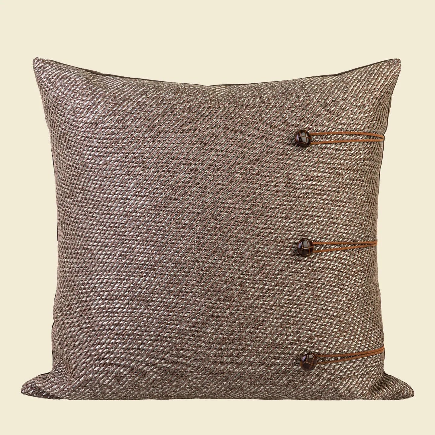 Chinese style square cushion in brown Maillard colour on a sofa.