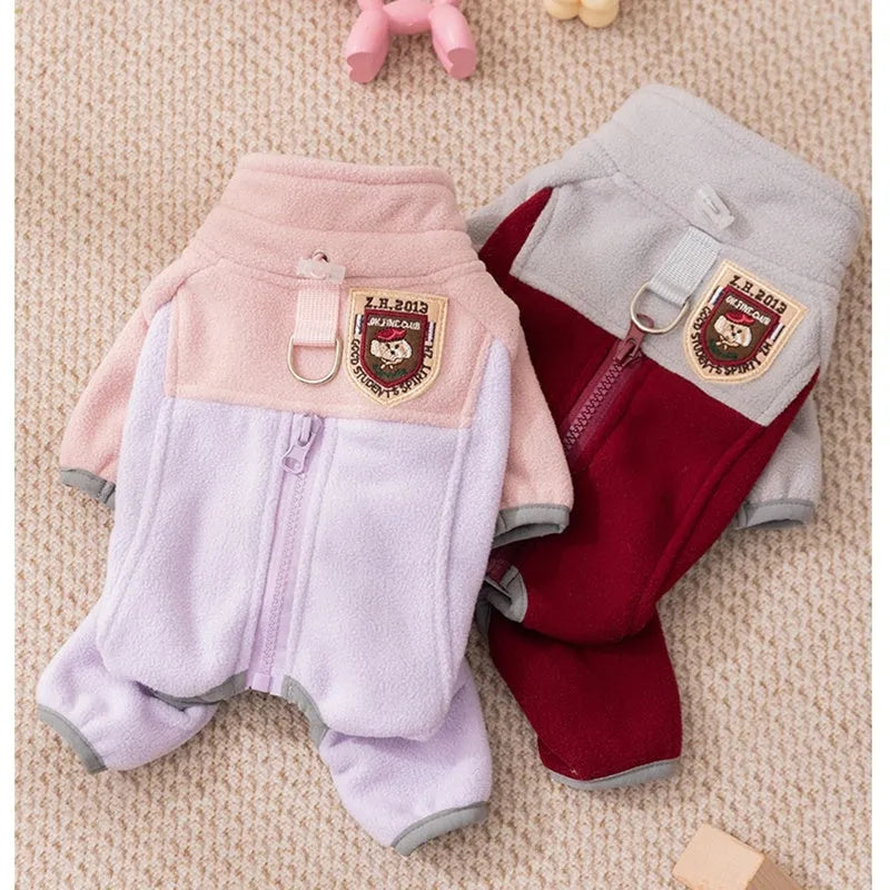 Four-legged fleece jacket for cats and small dogs in colour block design with badge patch, showing front zipper and elastic cuffs.