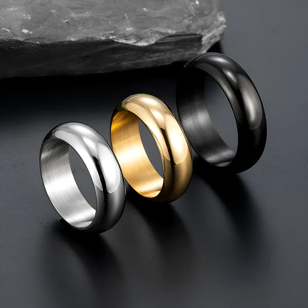 A glossy electroplated titanium steel ring in a gold colour, shown on a finger.