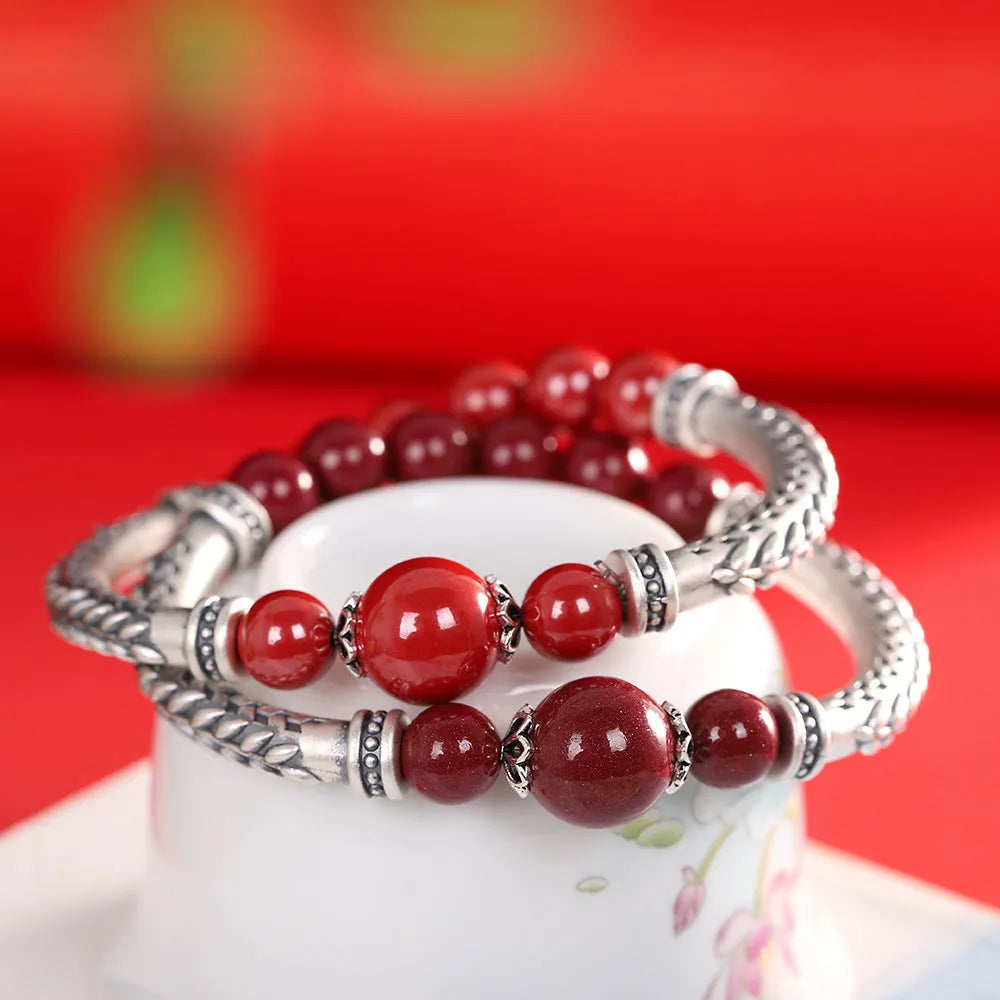 Pure silver 999 cinnabar bracelet with 10mm round retro geometric beads on neutral background