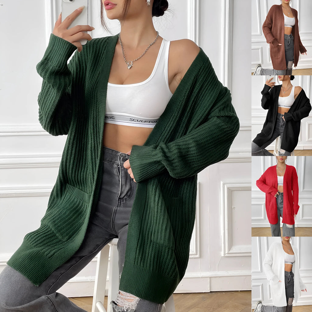 Women's dark green double pocket casual cardigan sweater laid flat.