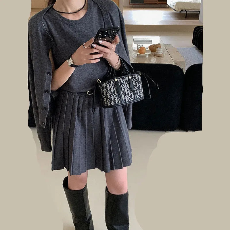 Grey knitted two-piece set with 3D pattern, featuring a belted vest skirt and long-sleeve cardigan.
