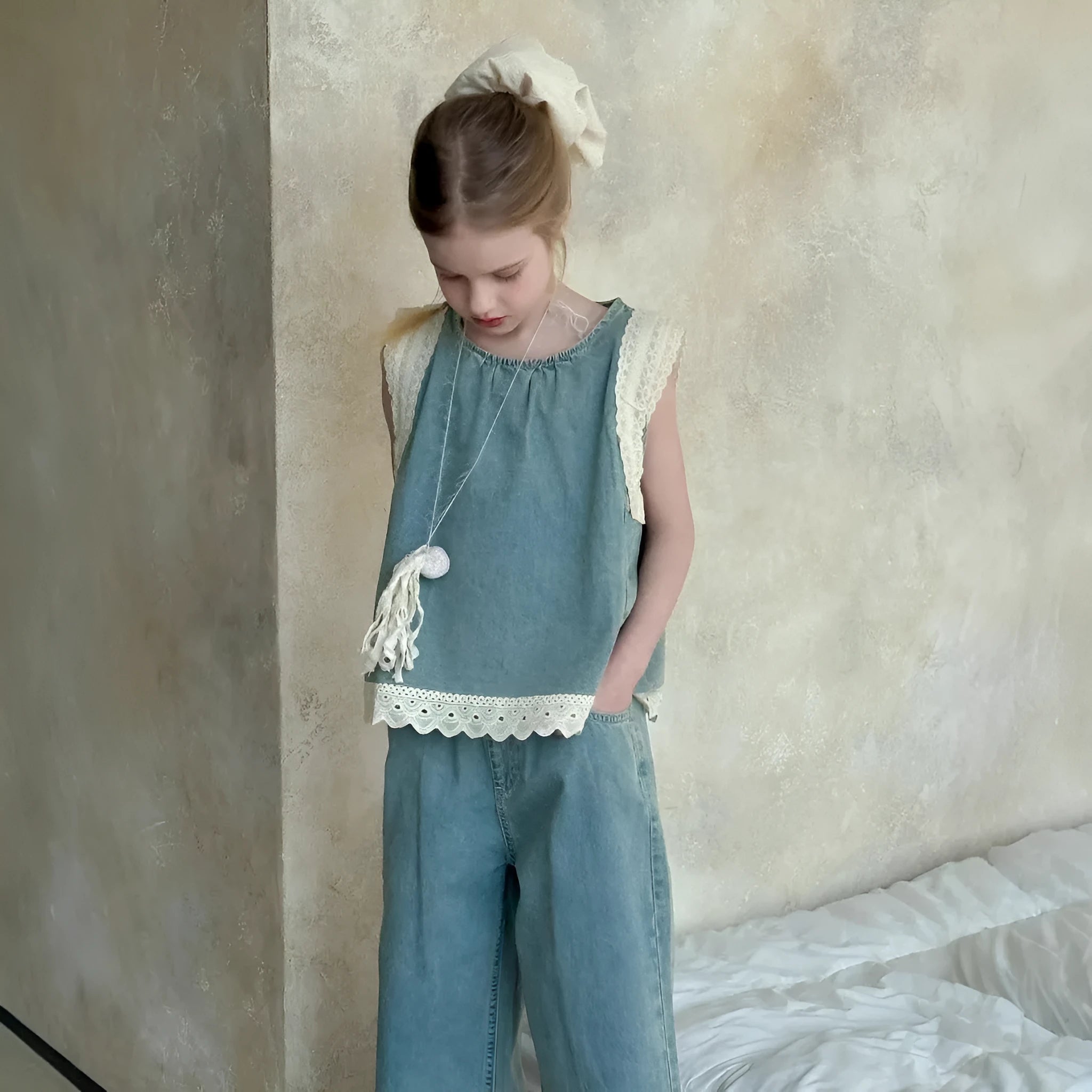 Girls' light blue cotton denim two-piece set with lace trim sleeveless vest and cropped wide-leg pants on child model