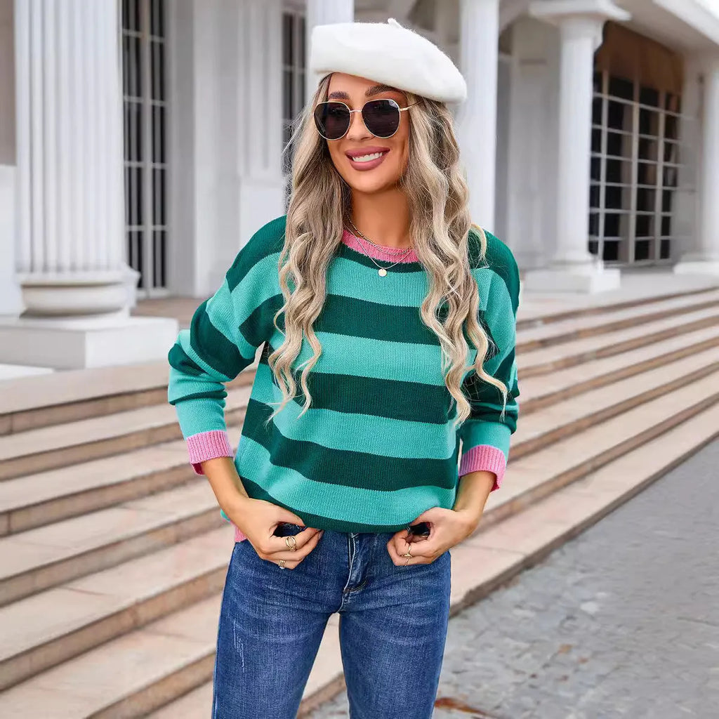 Loose fit blue women's acrylic sweater with round neck and long sleeves laid flat.