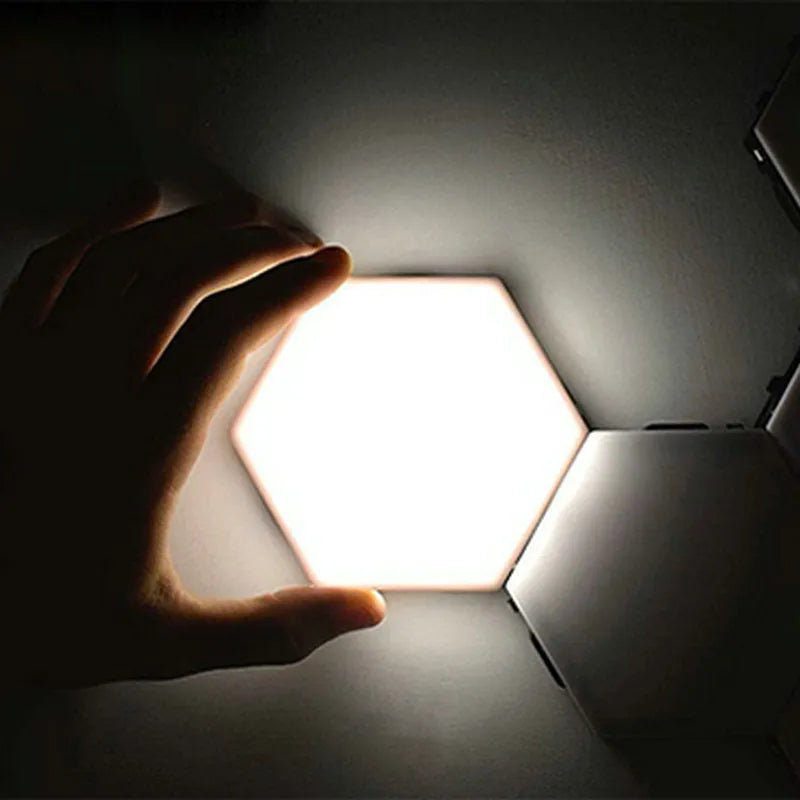 Close up of a modular hexagon LED wall light in a honeycomb pattern with multiple colour panels