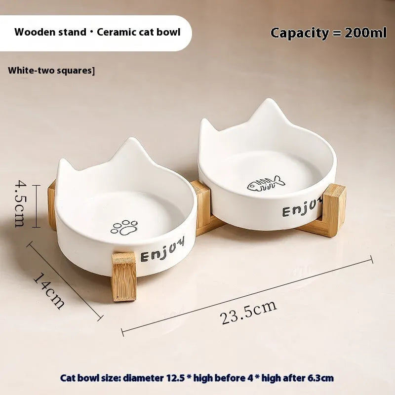 Porcelain cat bowl with cat ear and paw design on a wooden feeding frame, in pink colour.