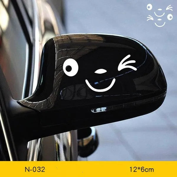 Pair of reflective cartoon eye car stickers on a vehicle rearview mirror and door panel.