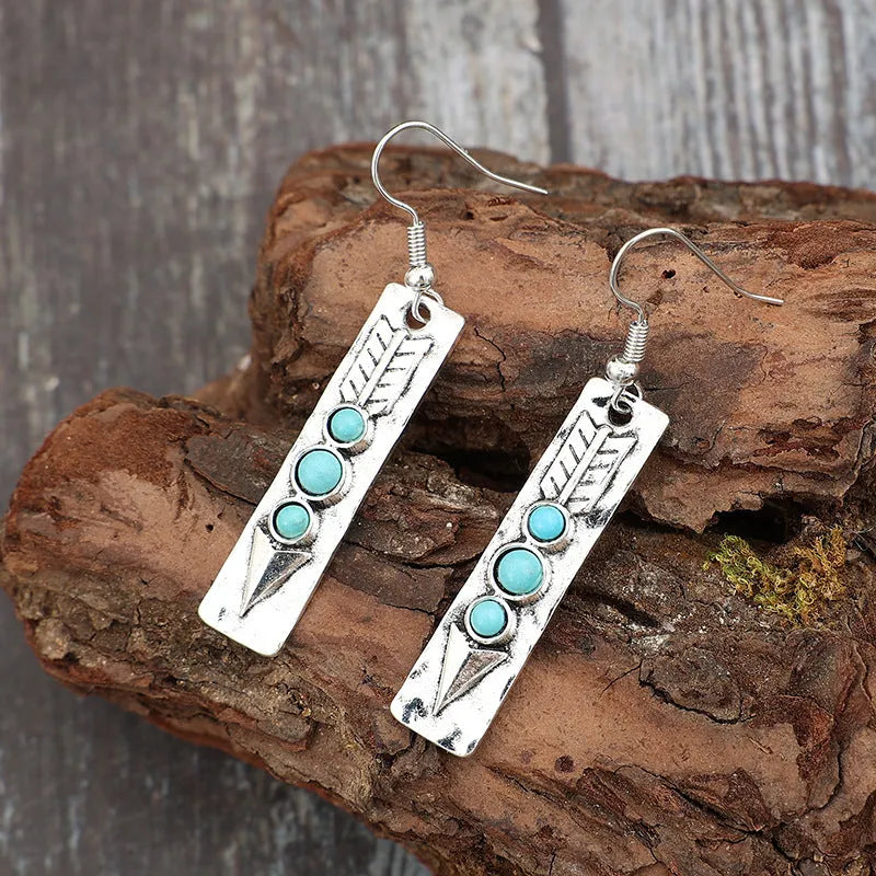 Silver geometric drop earrings with turquoise inlay detailing on long strip design