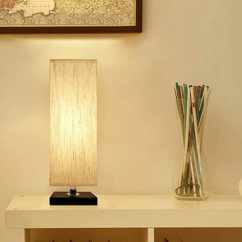 Modern square cloth covered table lamp with E26 socket on a wooden desk
