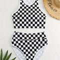 Women's black and white checkerboard racing one-piece swimsuit with backless design and suspender straps
