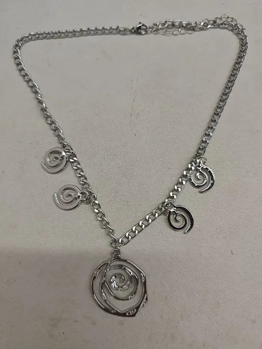 Spiral donut design jewellery set showing necklace, bracelet and ear hooks in gold finish
