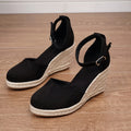 Women's apricot and black canvas wedge sandals with suede upper and buckle strap.