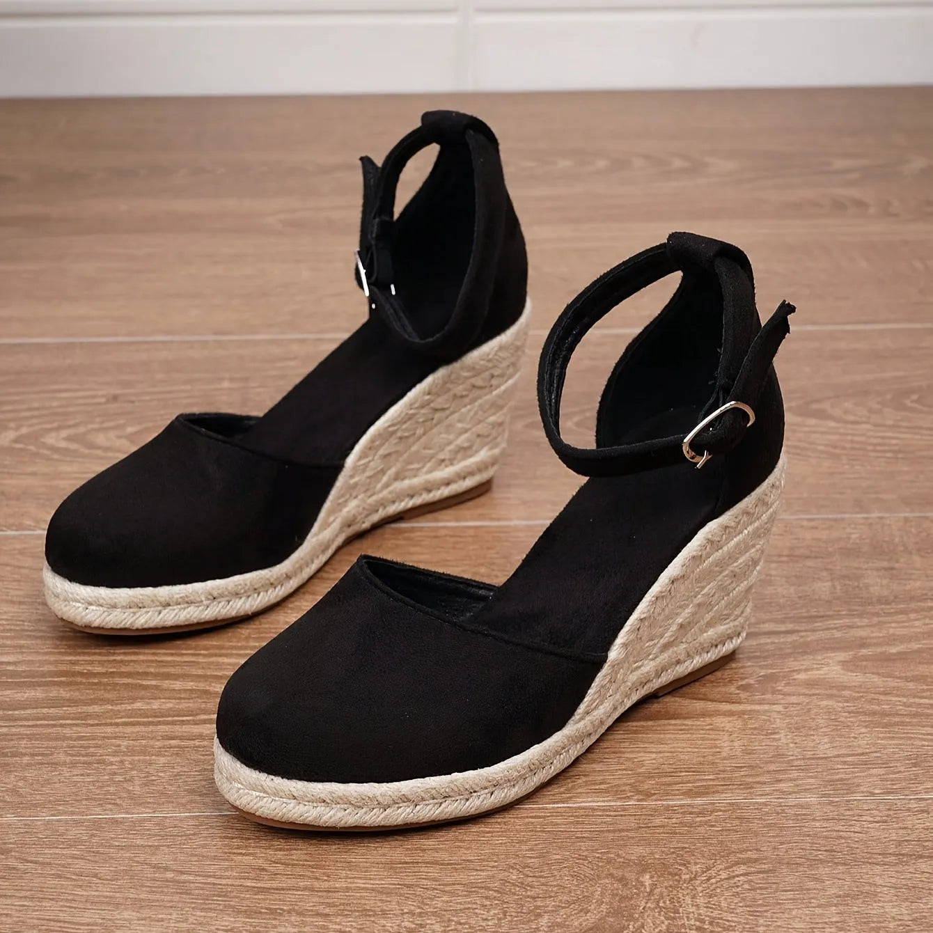 Women's apricot and black canvas wedge sandals with suede upper and buckle strap.