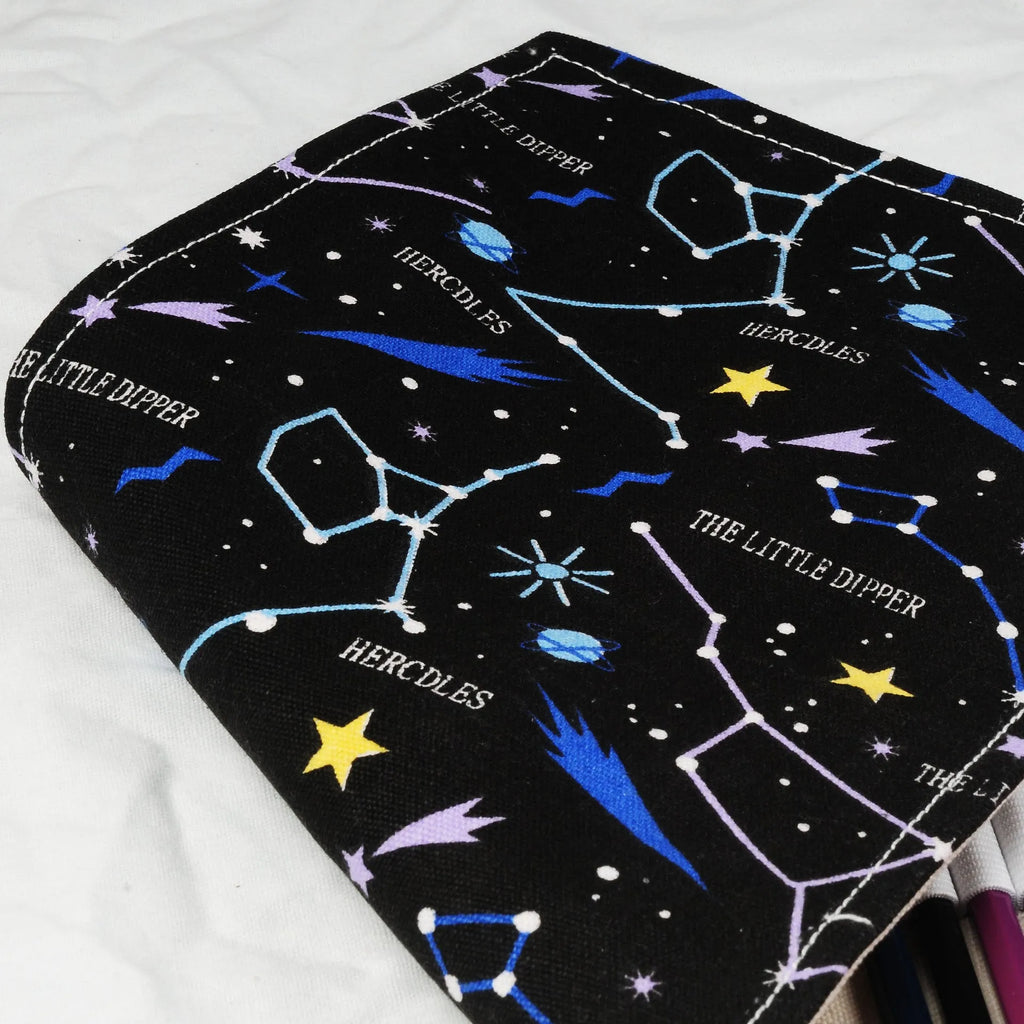Canvas pencil case roll with starry sky pattern showing organised colour pencil slots