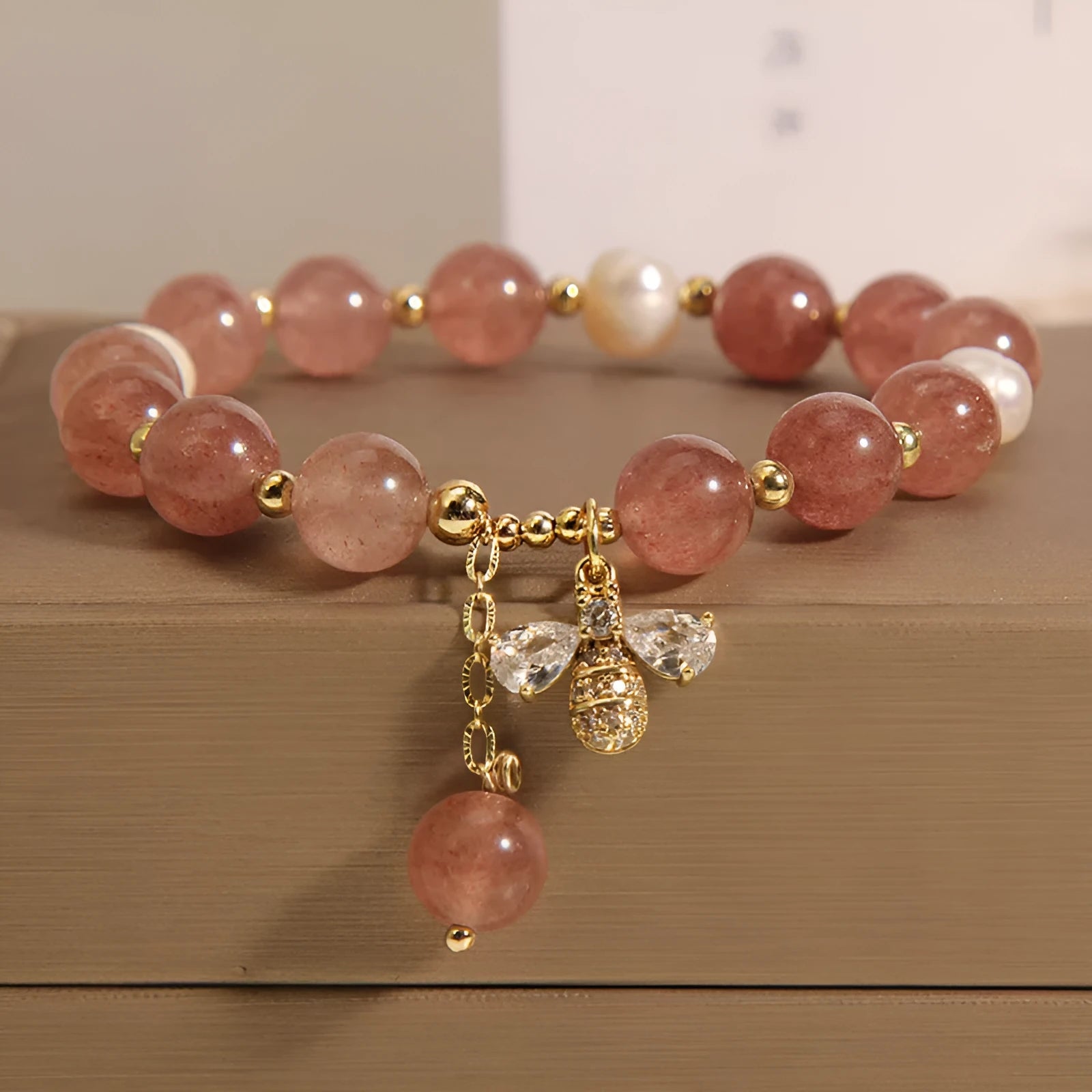 Women's bracelet with strawberry quartz stones, freshwater pearls, and zircon on an alloy chain.