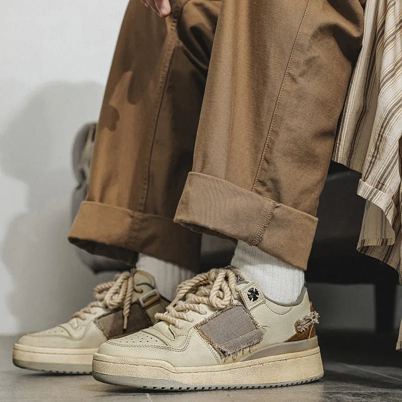 Beige low-top skateboard shoes with lace-up front and rubber soles
