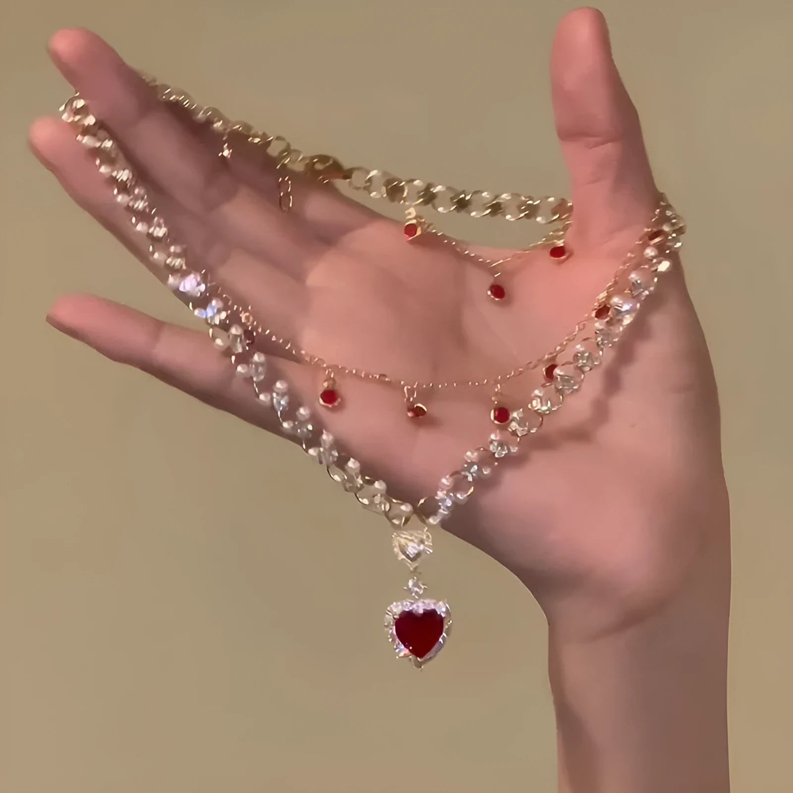 Red love heart pendant on a double layer alloy necklace with an adjustable chain.