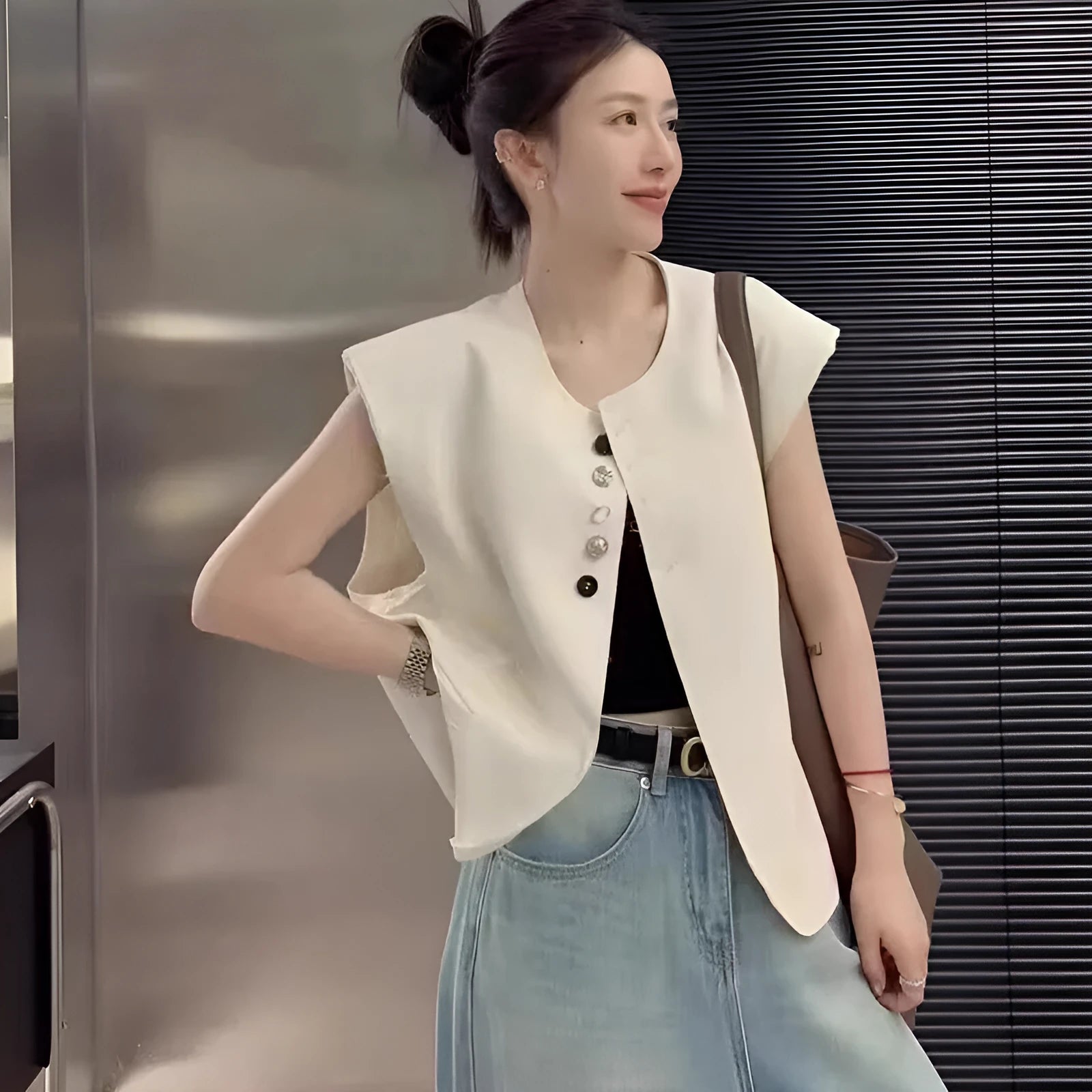 Women's loose-fit polyester vest in solid colour with a pocket, shown in milky white.